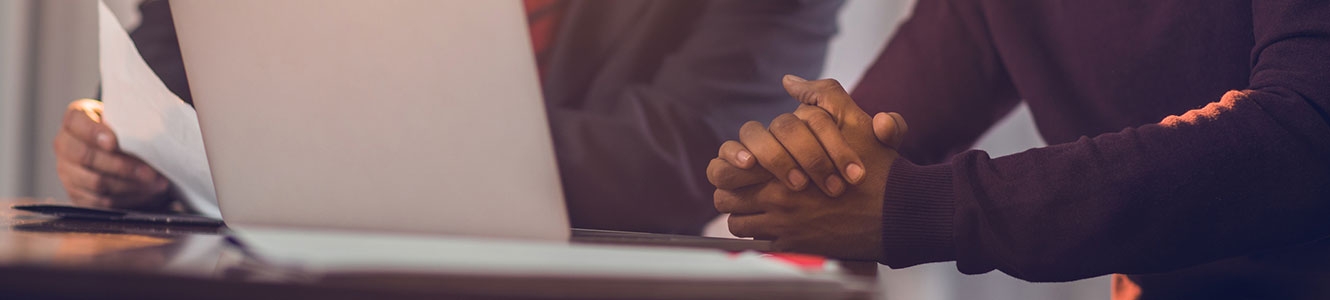 Two men looking at a laptop