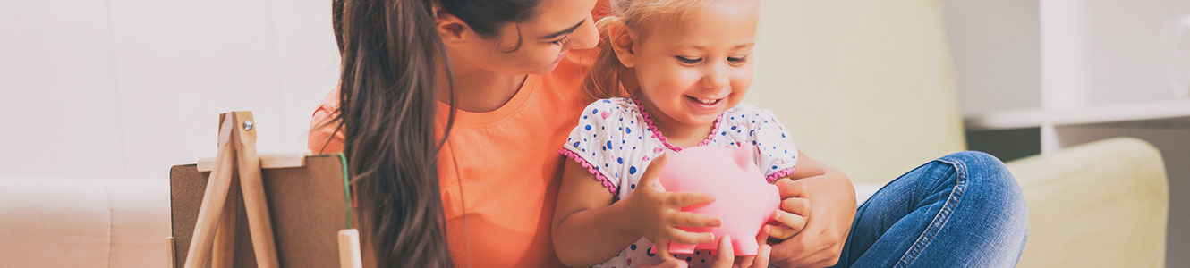 Mom and daughter with a piggy bank