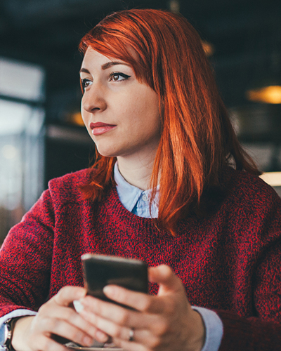 Lady on smartphone in a restaurant