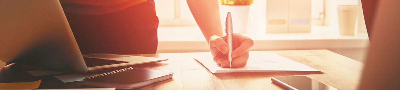 Person writing in an office