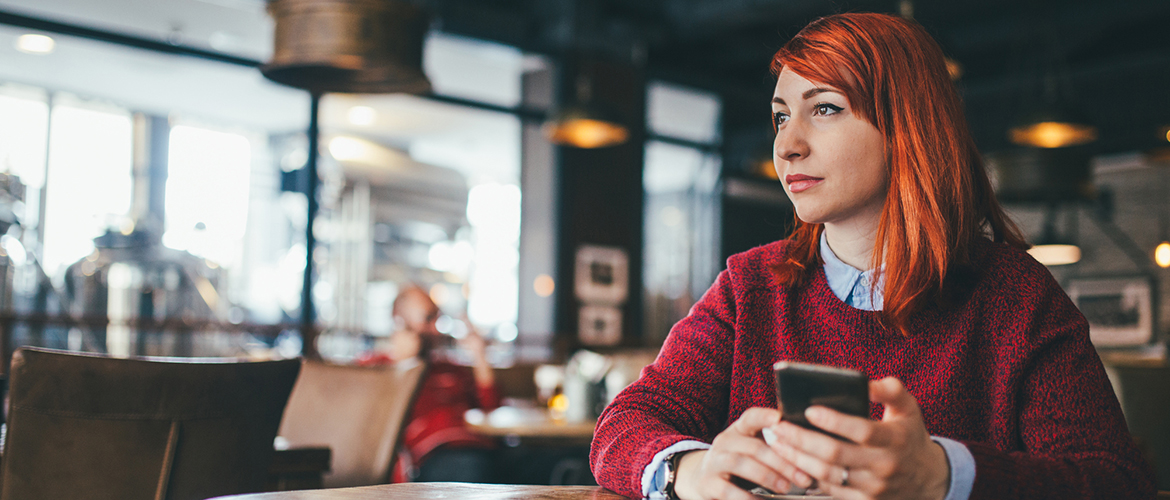 Lady on smartphone in a restaurant