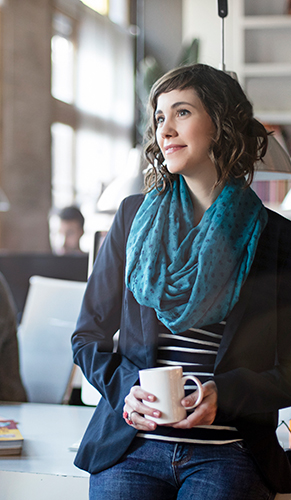 Lady drinking coffee in an office