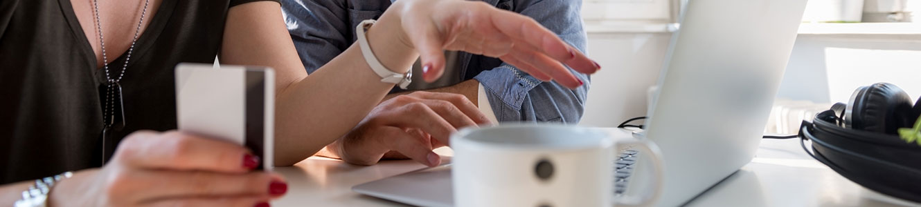 Couple with card on a laptop